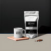 Coffee bag and mug with 'S5 Coffee' branding on a dark background